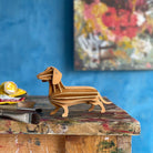 Lovi Dachshund, wooden dachshund figure, cinnamon brown, on painty stool